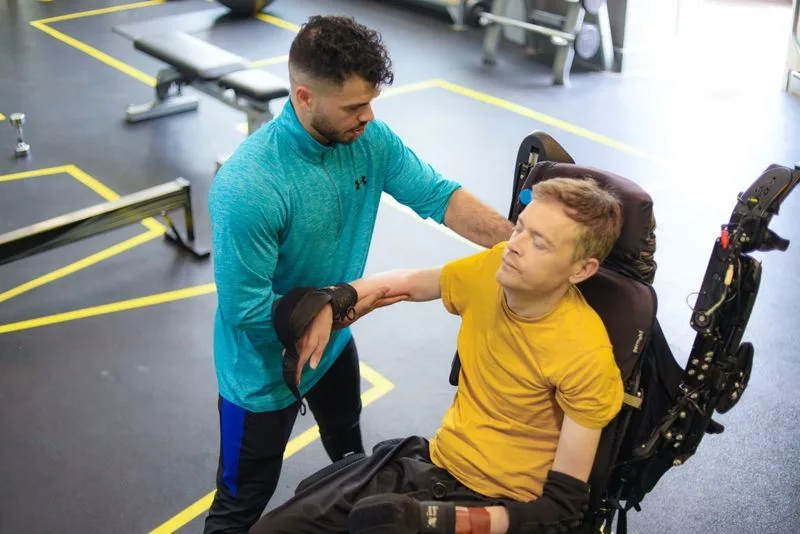 Trainer supporting a client during exercise