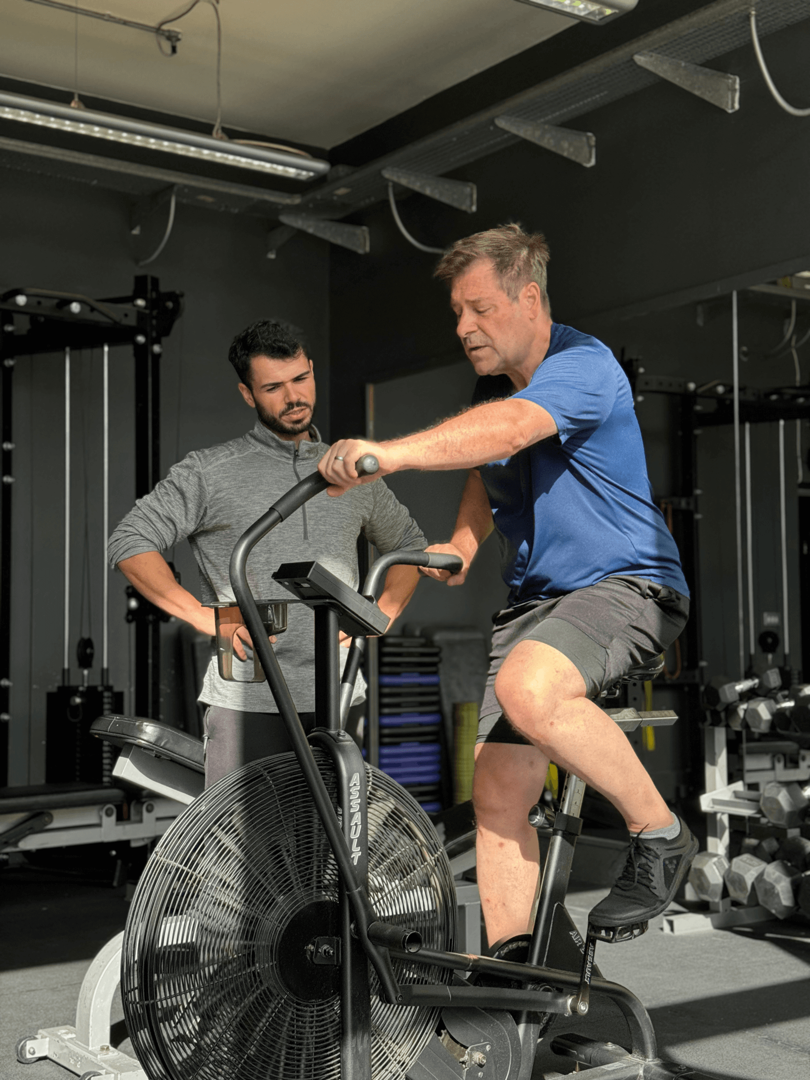 Personal trainer supporting a client