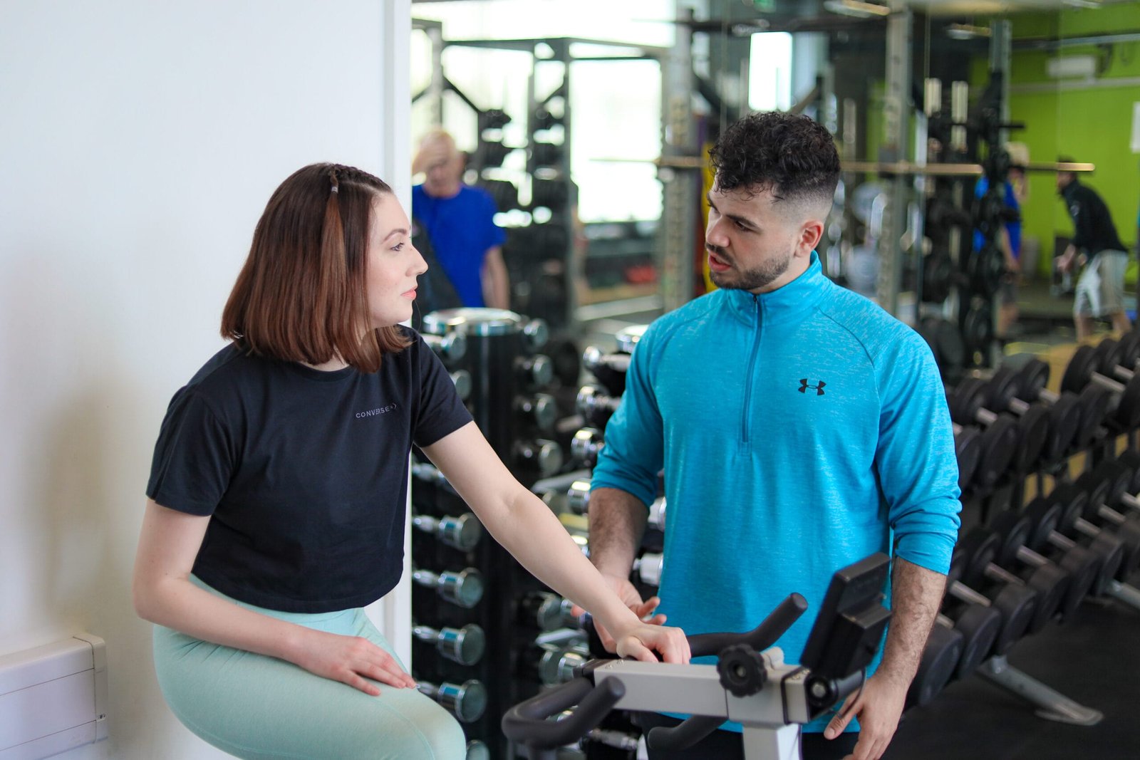 Personal trainer supporting a client